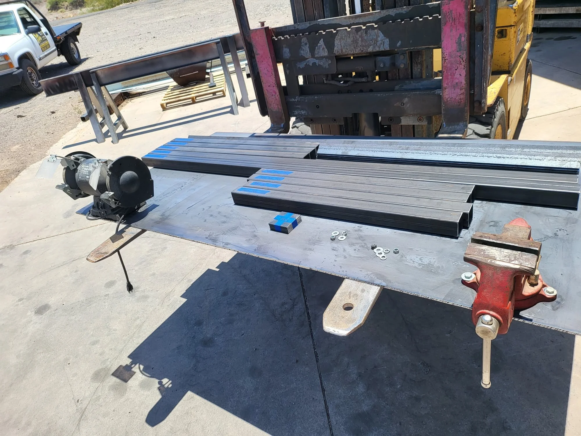Steel tube and stock arranged on a Peck's Welding shop worktable